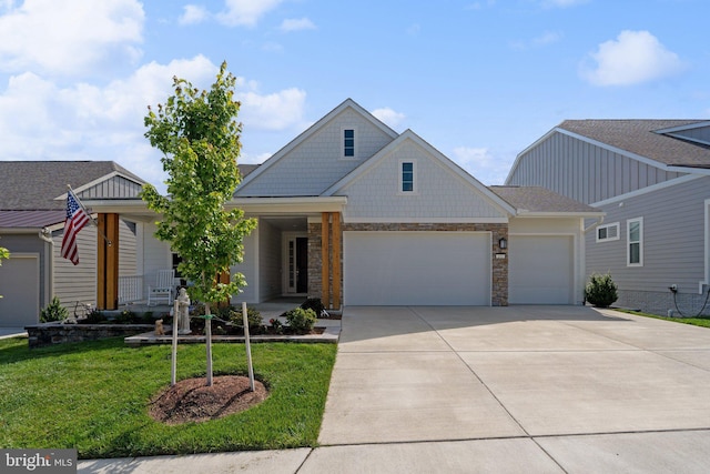 view of front of house featuring a garage, a porch, and a front yard