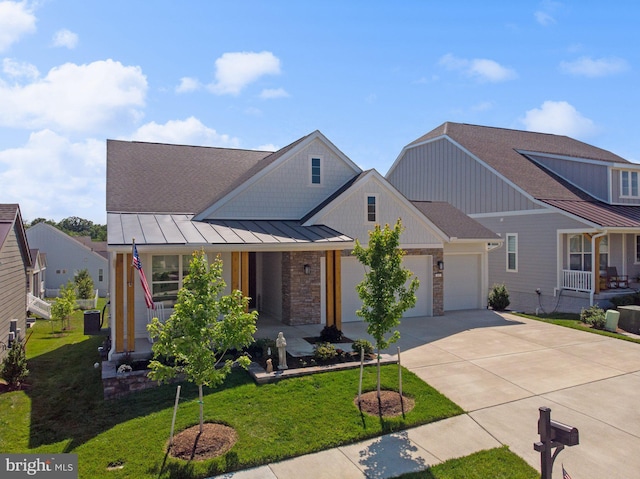 view of front facade featuring a garage, covered porch, and a front yard