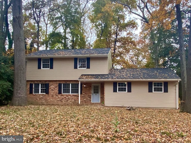 traditional home featuring brick siding