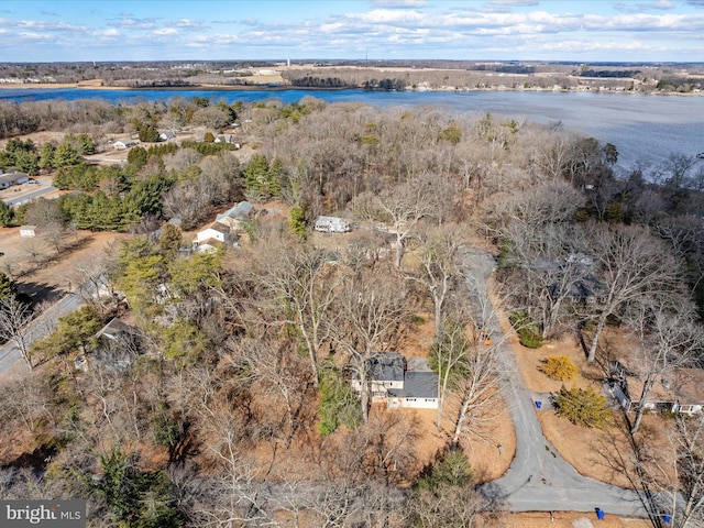 drone / aerial view featuring a water view and a forest view