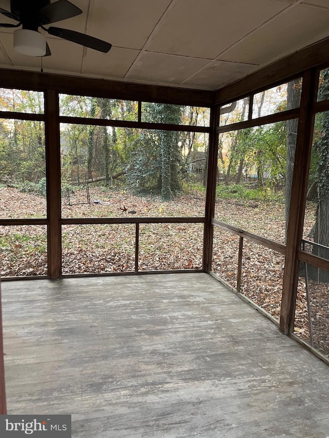 unfurnished sunroom featuring a ceiling fan