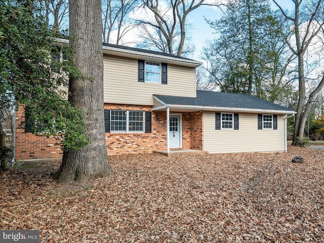 traditional-style house featuring brick siding