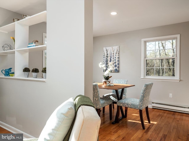 dining area featuring a baseboard heating unit, recessed lighting, baseboards, and hardwood / wood-style floors