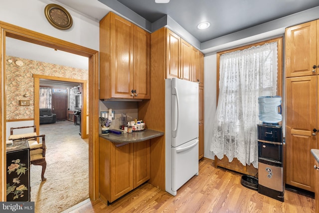 kitchen featuring white fridge and light carpet