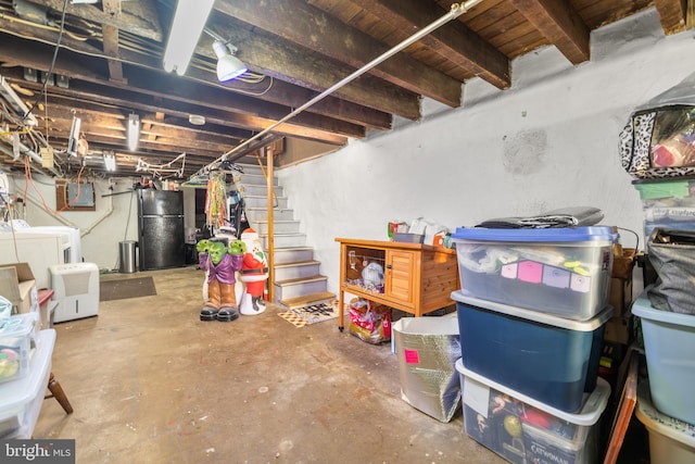 basement featuring black fridge and washer and dryer