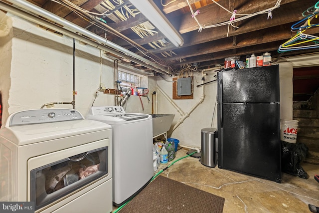 laundry area featuring washer and clothes dryer and electric panel