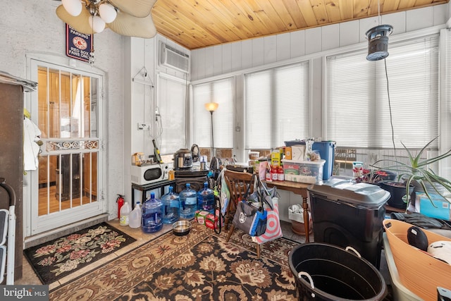 sunroom / solarium with ceiling fan, wooden ceiling, and an AC wall unit