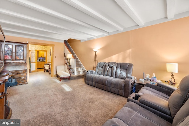 living room featuring beam ceiling and carpet floors