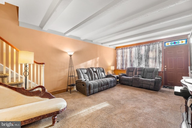 carpeted living room featuring beamed ceiling