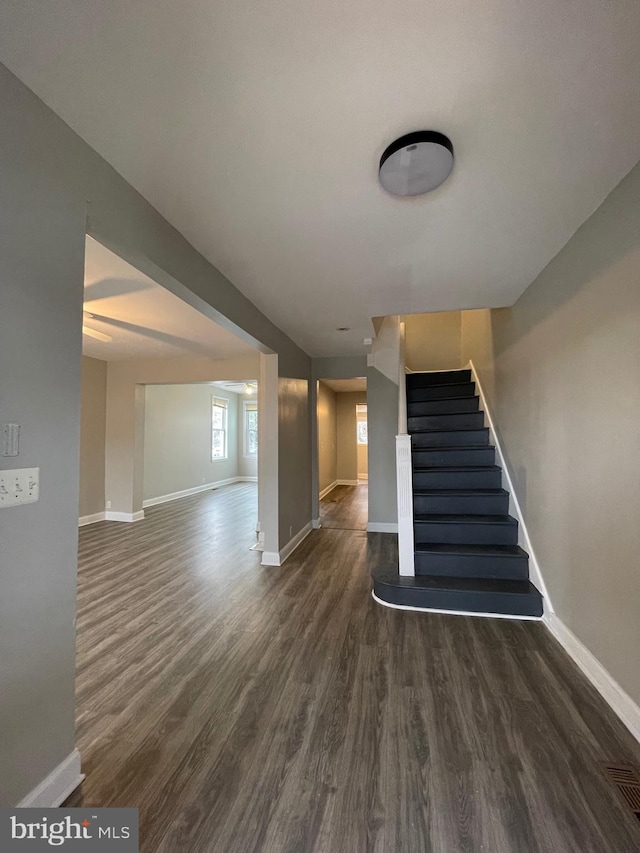 stairs featuring hardwood / wood-style floors