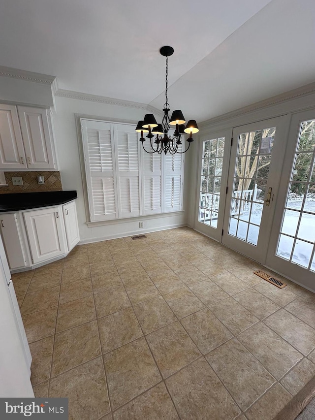 unfurnished dining area featuring an inviting chandelier and light tile patterned floors