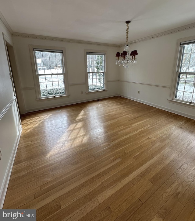 unfurnished dining area featuring a chandelier and light hardwood / wood-style flooring