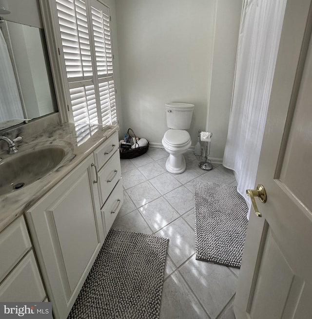 bathroom featuring vanity, toilet, and tile patterned flooring