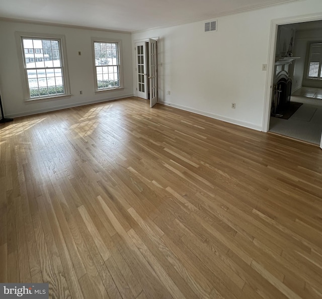 spare room with light hardwood / wood-style floors and ornamental molding