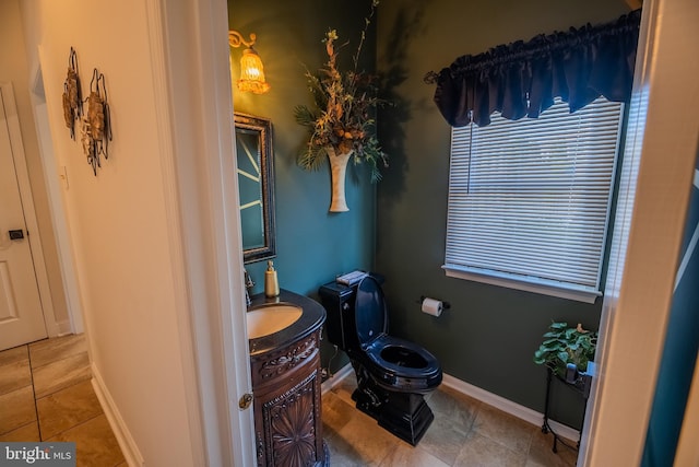 bathroom with vanity, tile patterned flooring, and toilet