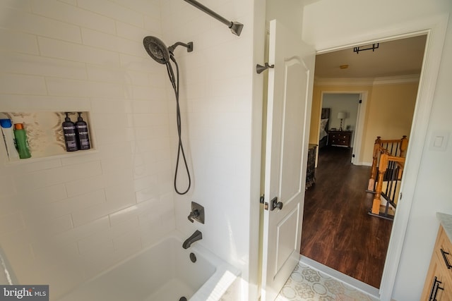 bathroom featuring crown molding, wood-type flooring, vanity, and shower / bathtub combination