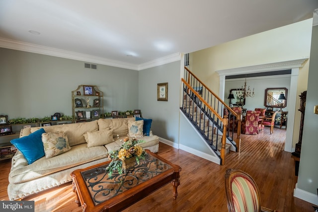 living room with crown molding and hardwood / wood-style flooring