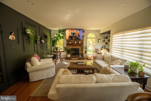 living room with hardwood / wood-style floors and a fireplace