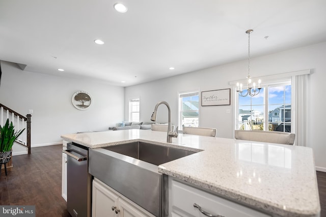 kitchen with white cabinetry, hanging light fixtures, sink, dishwasher, and dark hardwood / wood-style floors