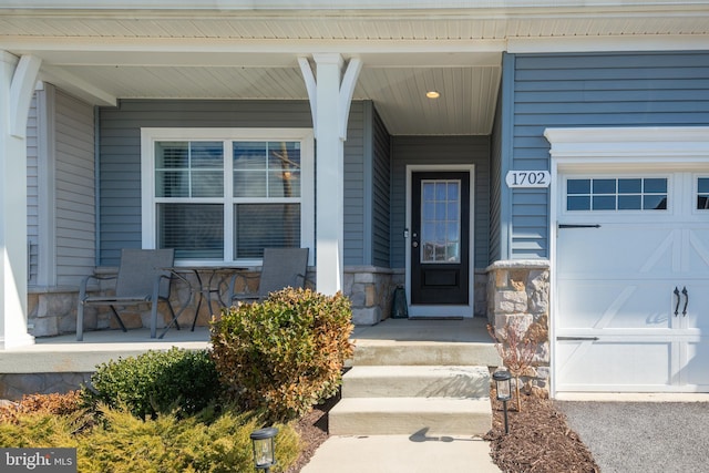 property entrance with a garage and a porch