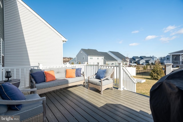 wooden terrace featuring area for grilling and outdoor lounge area