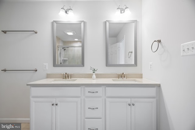 bathroom featuring vanity and a shower with door