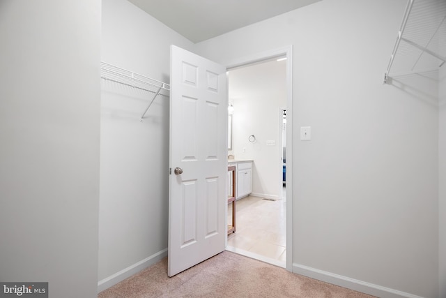 spacious closet with light colored carpet