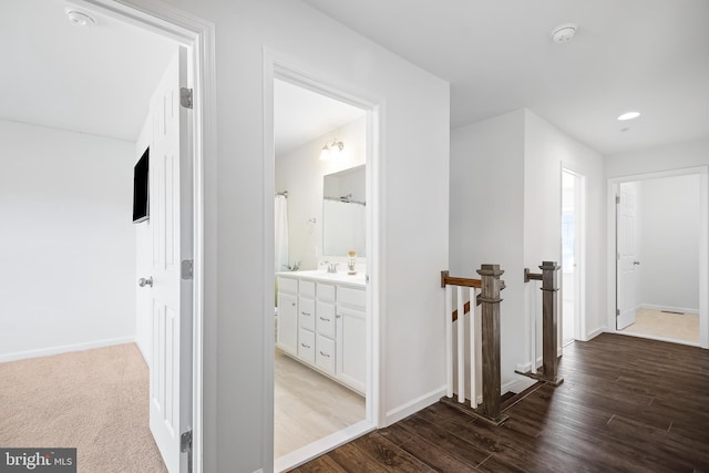 hall with hardwood / wood-style floors and sink