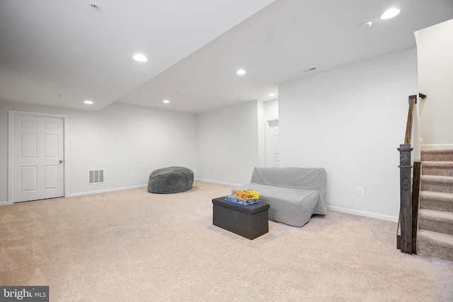 living area featuring light colored carpet