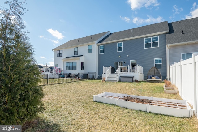 back of property with a deck and a lawn