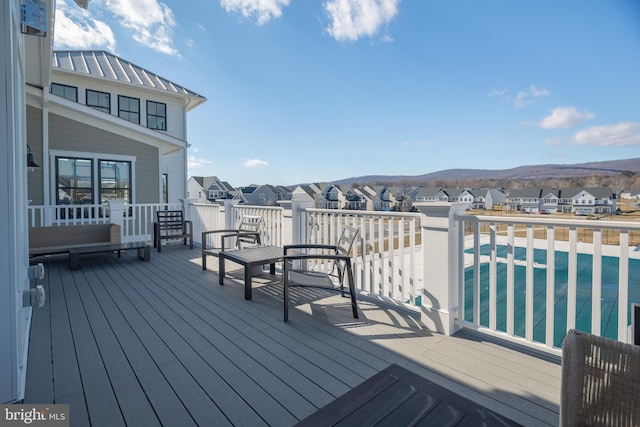 wooden deck with a covered pool and a mountain view