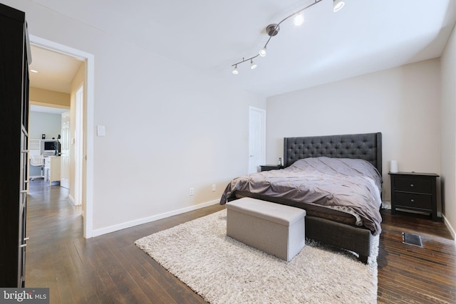 bedroom with dark hardwood / wood-style floors