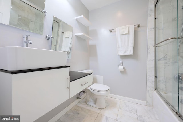 full bathroom with vanity, toilet, and combined bath / shower with glass door