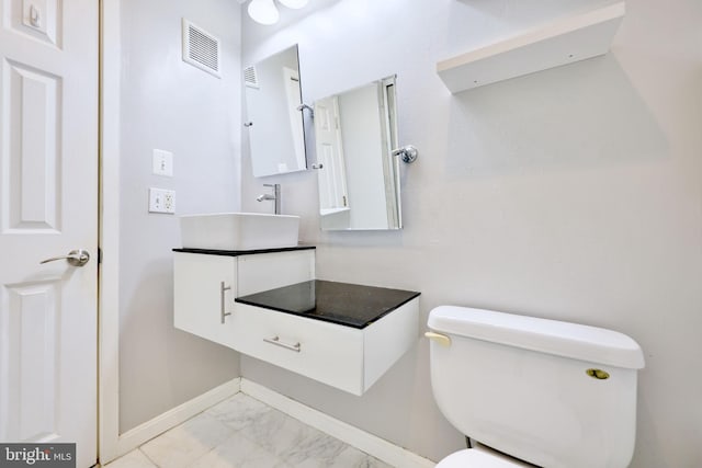 bathroom featuring vanity and toilet