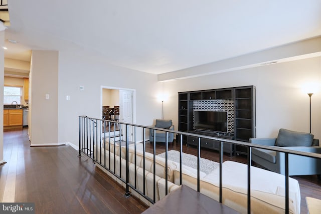 hallway with sink and dark hardwood / wood-style flooring