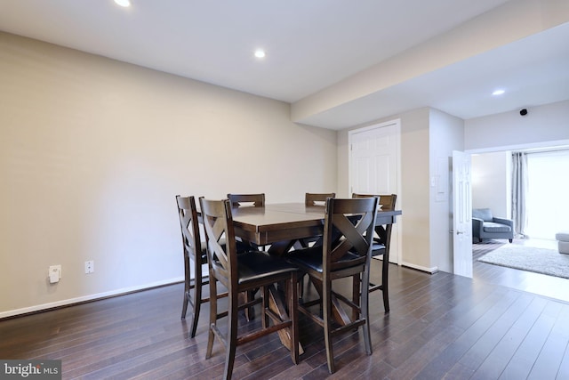 dining space with dark hardwood / wood-style floors