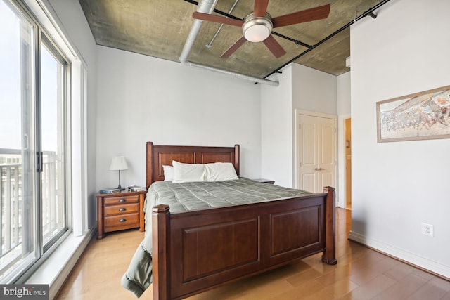 bedroom with ceiling fan and light hardwood / wood-style floors