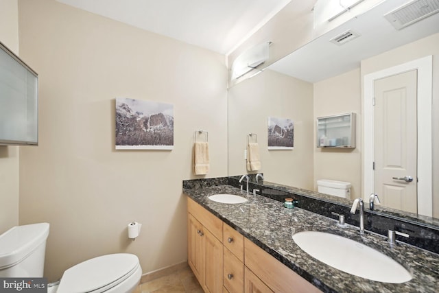 bathroom featuring vanity, toilet, and tile patterned floors