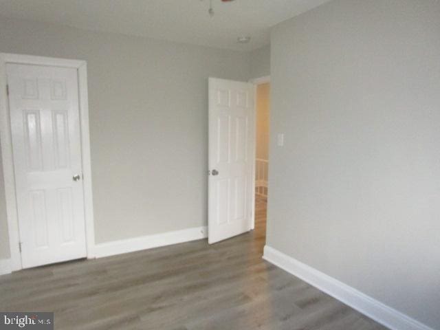 empty room with dark hardwood / wood-style flooring