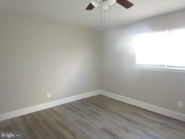 unfurnished room featuring hardwood / wood-style floors and ceiling fan