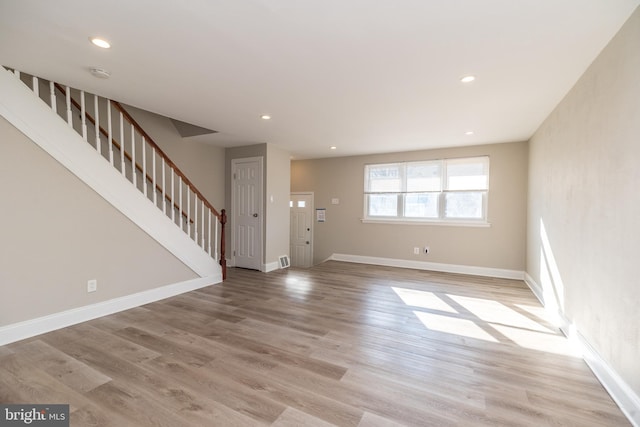 unfurnished living room featuring light wood-type flooring