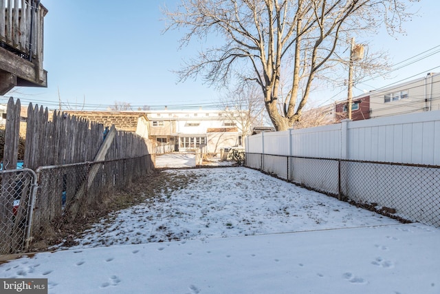 view of yard layered in snow