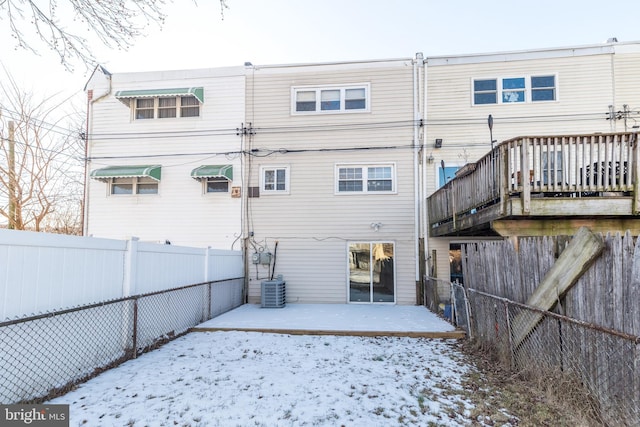 snow covered property featuring central air condition unit