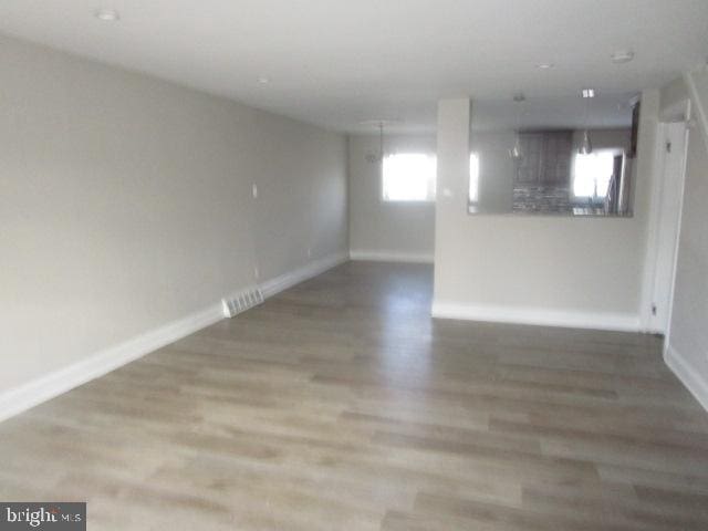 unfurnished room featuring hardwood / wood-style flooring