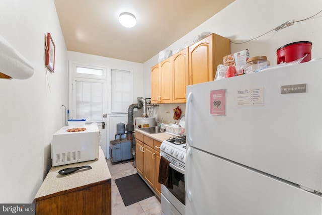 kitchen with white appliances and light tile patterned floors