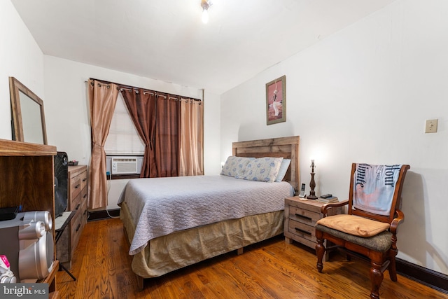 bedroom with hardwood / wood-style flooring and cooling unit