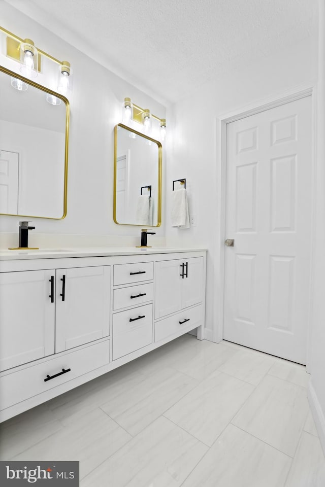 bathroom with vanity and a textured ceiling