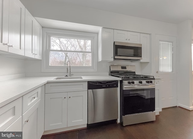 kitchen with sink, white cabinetry, and appliances with stainless steel finishes