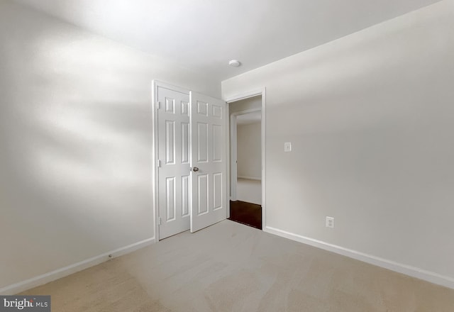 unfurnished bedroom with a closet and carpet flooring