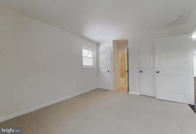 unfurnished bedroom featuring light colored carpet